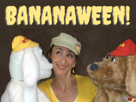 Bananaween! A woman holds two dog puppets facing each other.